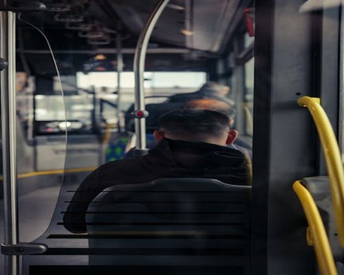Passenger inside city transit looking ahead calmly without looking at their phone screen